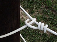 knot on end post of horse fence with Supercote wire